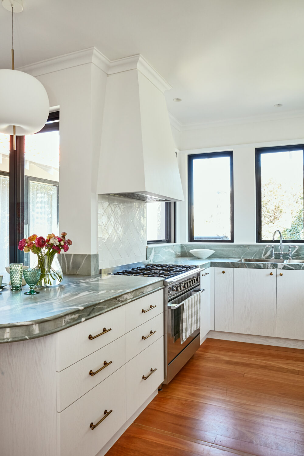 White kitchen joinery with woven panels and brass hardware — view 3