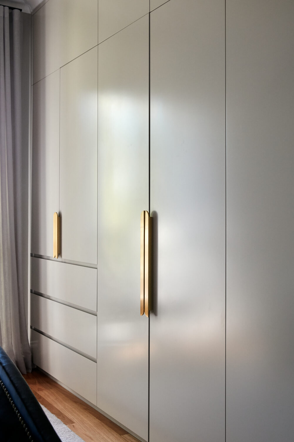 White kitchen joinery with woven panels and brass hardware — view 4