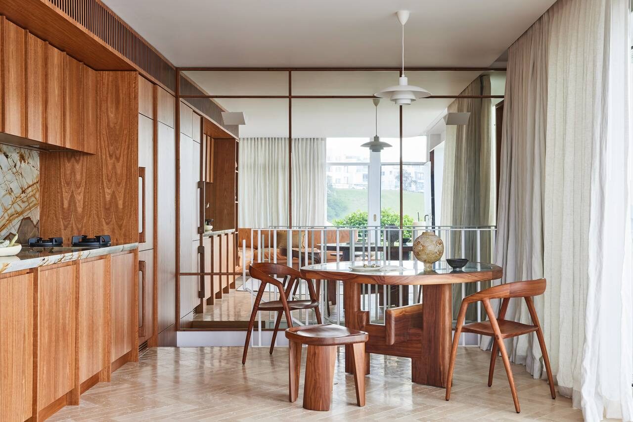 Warm timber kitchen with rust-veined stone — view 2